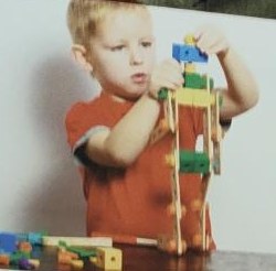 Child building a tower with colourful blocks